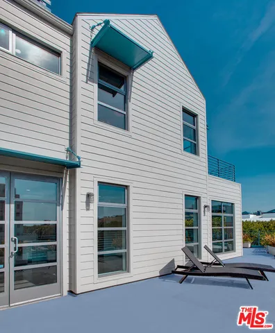 a backyard of a house with outdoor seating