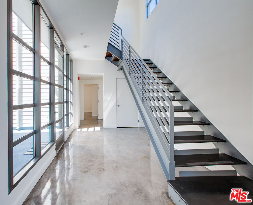 1358 4th Street, Unit A Santa Monica, CA 90401 - Photo 18 of 46 a view of staircase with lots of frames on wall and a large window