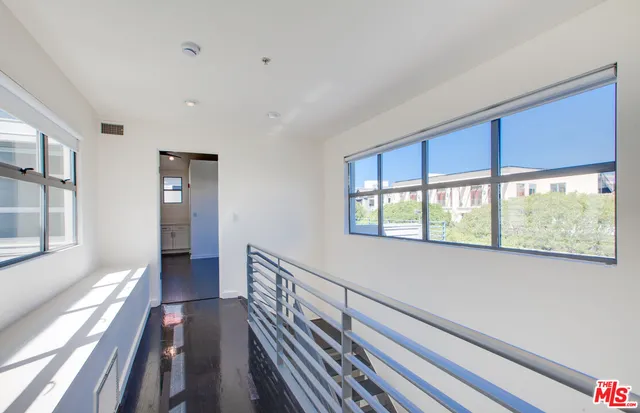 a view of wooden floor and windows in a room