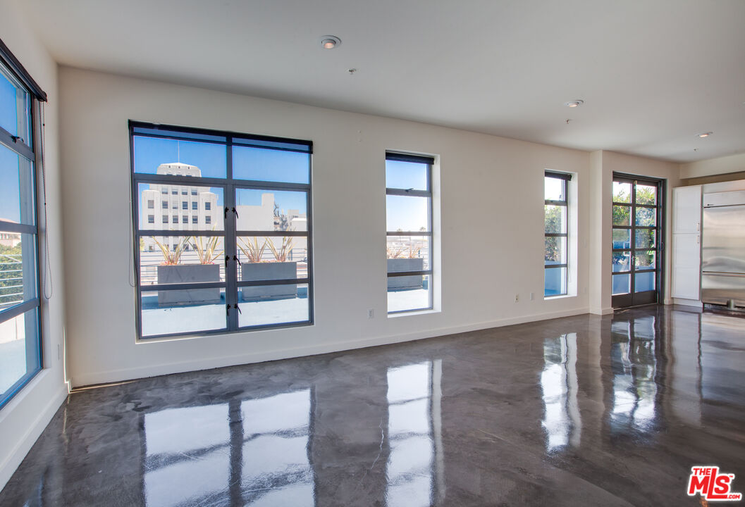 1358 4th Street, Unit A Santa Monica, CA 90401 - Photo 2 of 46 a view of an empty room with window and wooden floor