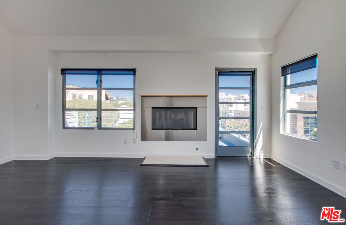 1358 4th Street, Unit A Santa Monica, CA 90401 - Photo 25 of 46 a view of an empty room with a window and wooden floor