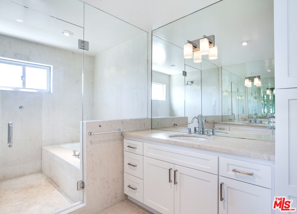 1358 4th Street, Unit A Santa Monica, CA 90401 - Photo 27 of 46 a bathroom with a sink double vanity granite tub and a mirror