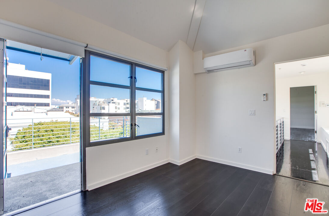 1358 4th Street, Unit A Santa Monica, CA 90401 - Photo 30 of 46 a view of an empty room with wooden floor and a window