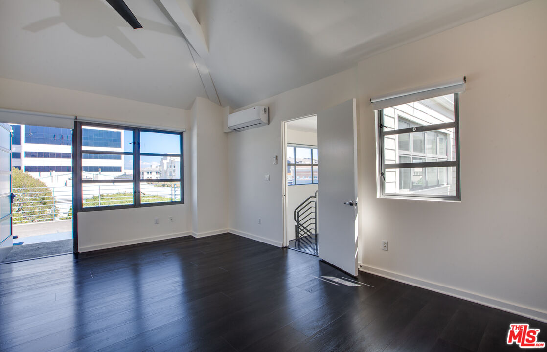 1358 4th Street, Unit A Santa Monica, CA 90401 - Photo 31 of 46 a view of an empty room with wooden floor and a window