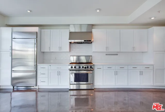 a kitchen with cabinets and stainless steel appliances