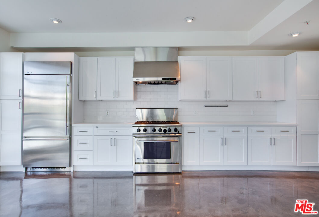1358 4th Street, Unit A Santa Monica, CA 90401 - Photo 4 of 46 a kitchen with cabinets and stainless steel appliances