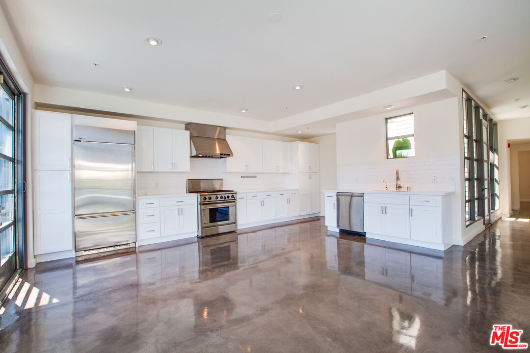 1358 4th Street, Unit A Santa Monica, CA 90401 - Photo 5 of 46 a view of a kitchen with furniture and an empty room