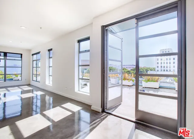 a living room with furniture and large window