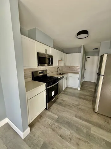 a kitchen with a stove a microwave and a refrigerator