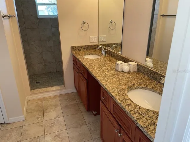 a white toilet and tub sitting next to a bathroom sink