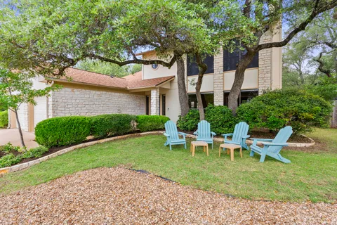 a view of a house with backyard sitting area and garden