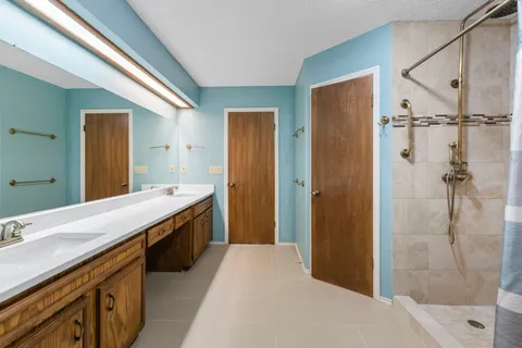 a spacious bathroom with a shower and a sink