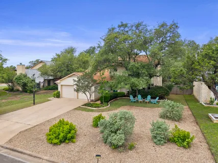 a view of a garden with a house in the background