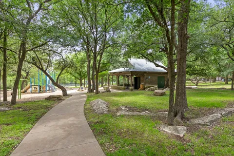 a view of a park with large trees
