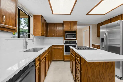 a kitchen with a stove a sink and a refrigerator