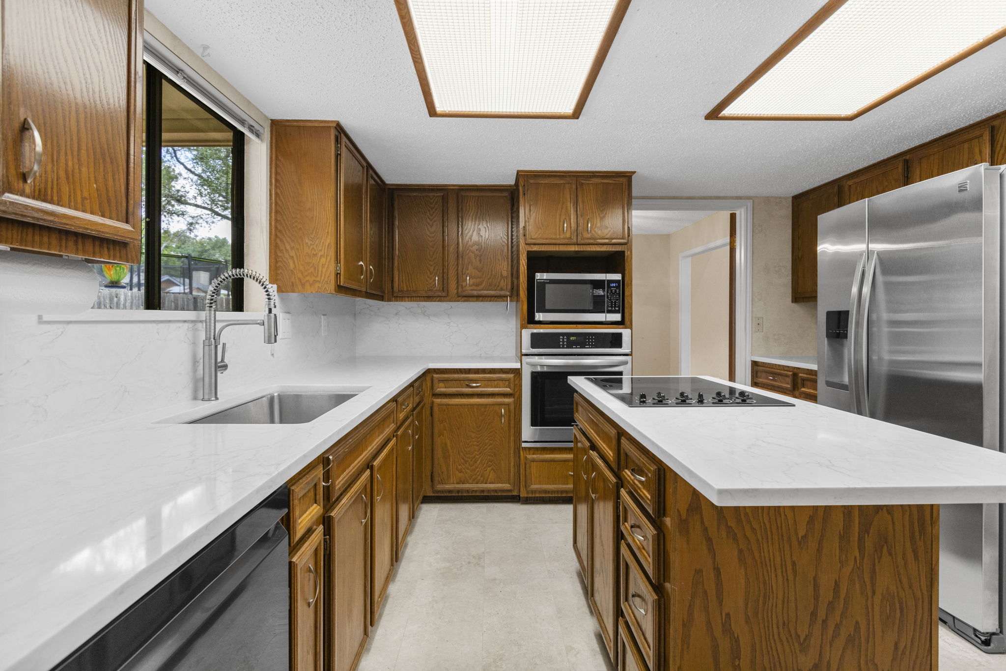 9006 Lockleven Loop Austin, TX 78750 - Photo 4 of 25 a kitchen with a stove a sink and a refrigerator