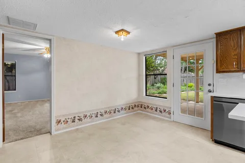a view of an empty room and a window