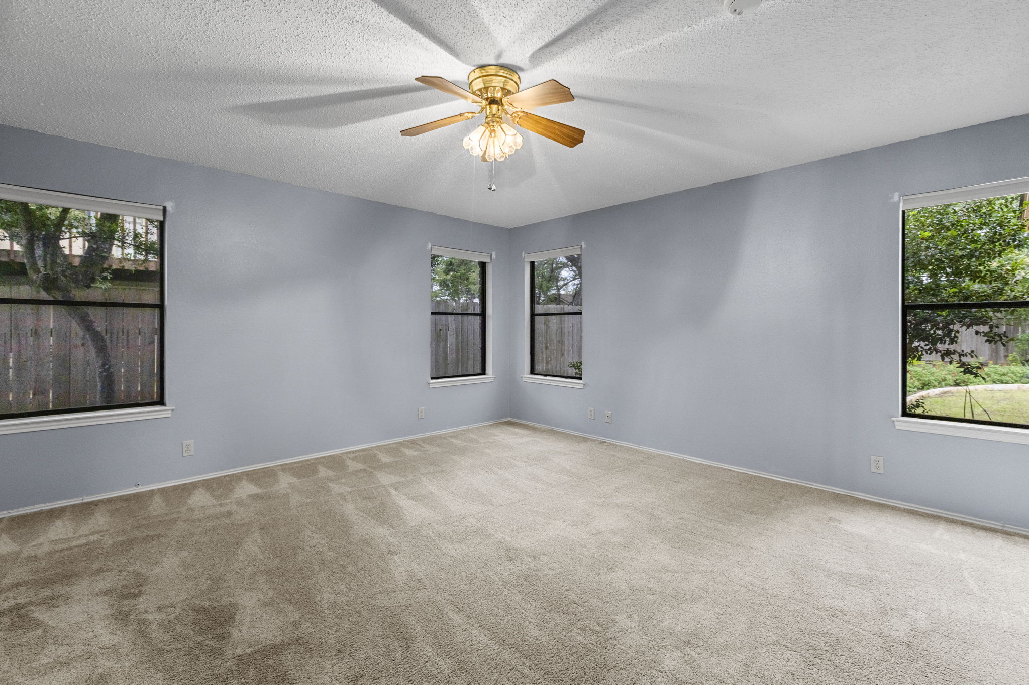 9006 Lockleven Loop Austin, TX 78750 - Photo 9 of 25 a view of an empty room with window and chandelier fan