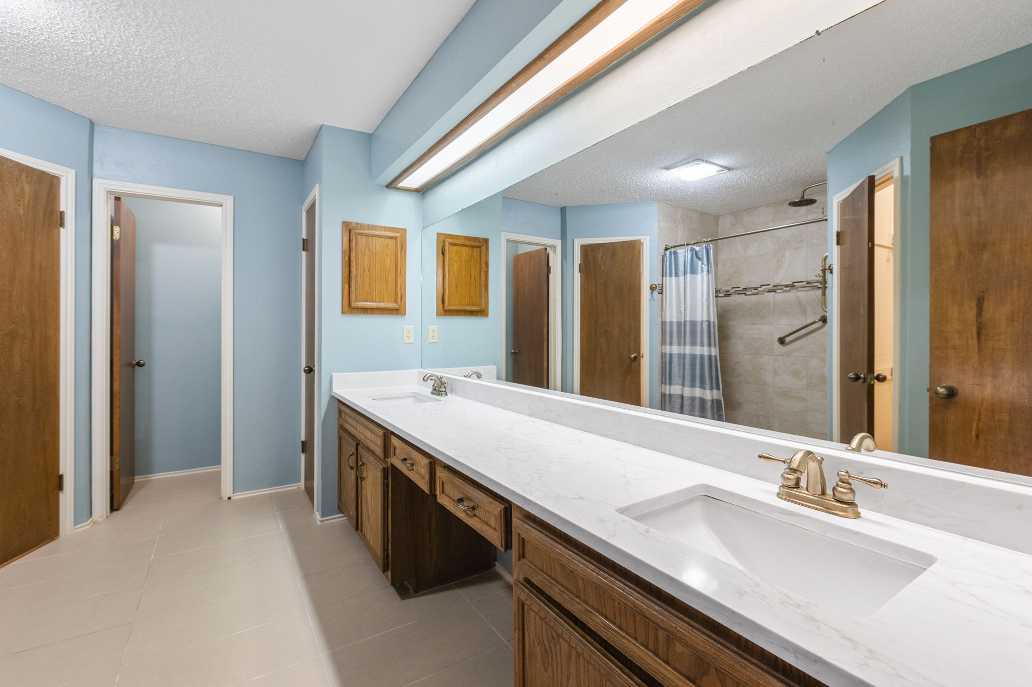 9006 Lockleven Loop Austin, TX 78750 - Photo 10 of 25 a spacious bathroom with a granite countertop sink and a mirror