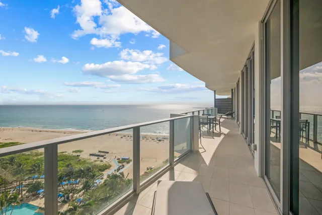 a view of balcony with table and chairs