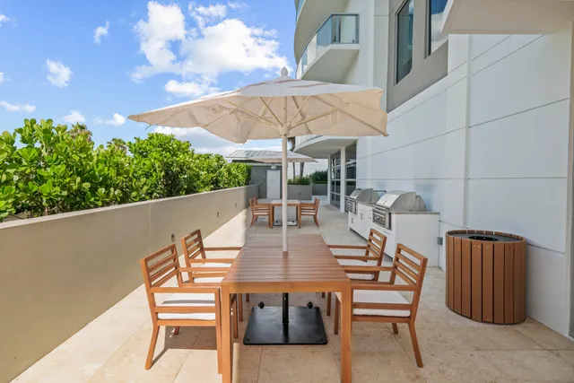 a dining room with furniture and a floor to ceiling window