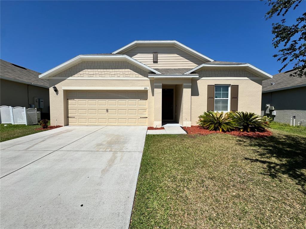 390 Honey Bell Road Winter Haven, FL 33880 - Photo 1 of 1 a front view of a house with garden
