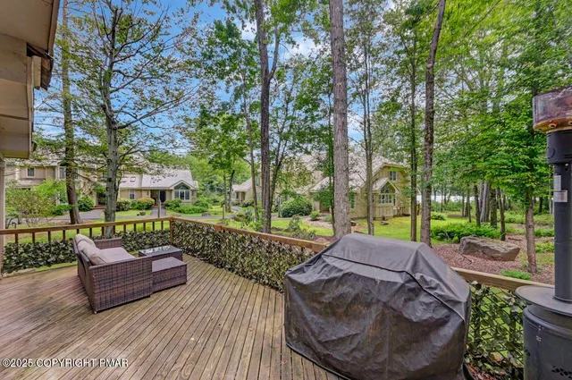 a view of a deck with couches and wooden fence