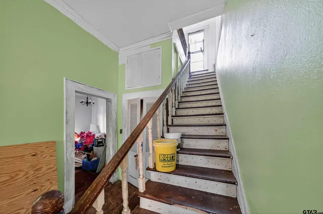 a view of a bedroom with furniture and a window