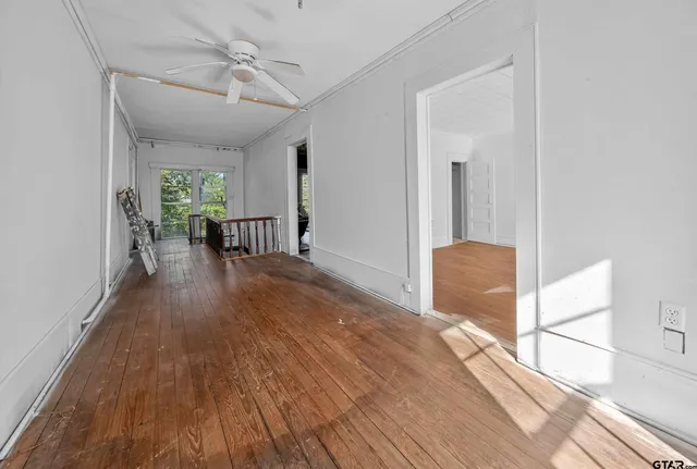 wooden floor in an empty room with a window