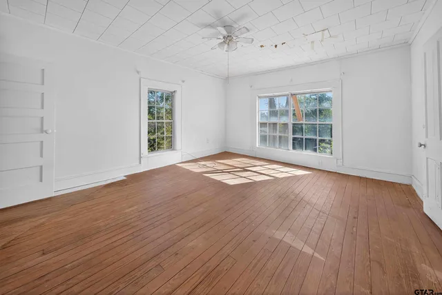 wooden floor in an empty room with a window