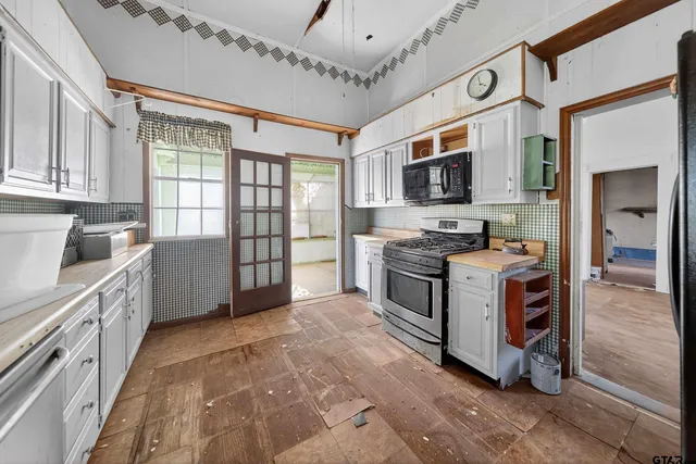 a kitchen with stainless steel appliances granite countertop a stove and a sink