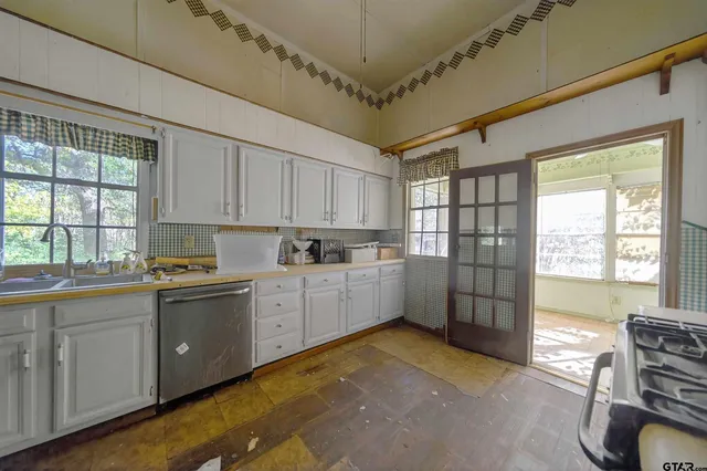 a kitchen with sink a window and stainless steel appliances
