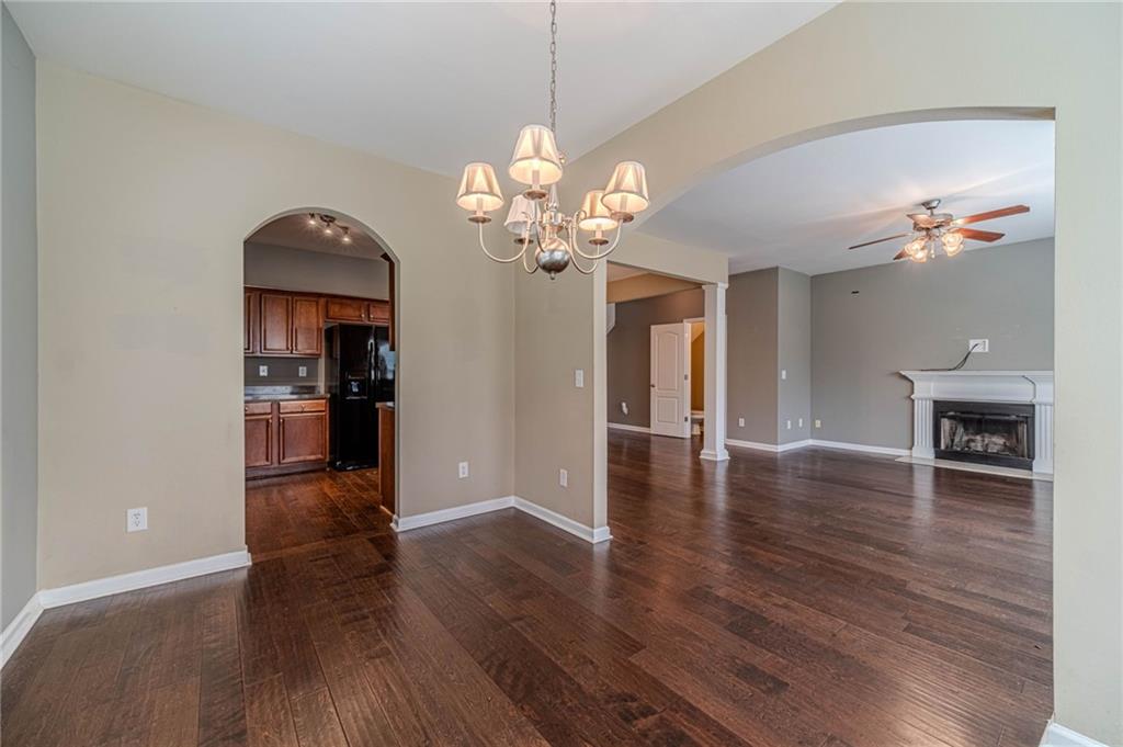 6503 Silk Tree Pointe Braselton, GA 30517 - Photo 15 of 47 a view of a livingroom with wooden floor and a kitchen space