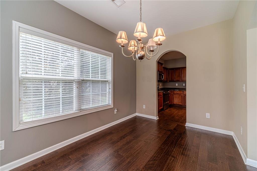 6503 Silk Tree Pointe Braselton, GA 30517 - Photo 16 of 47 a view of a room with wooden floor chandelier and windows