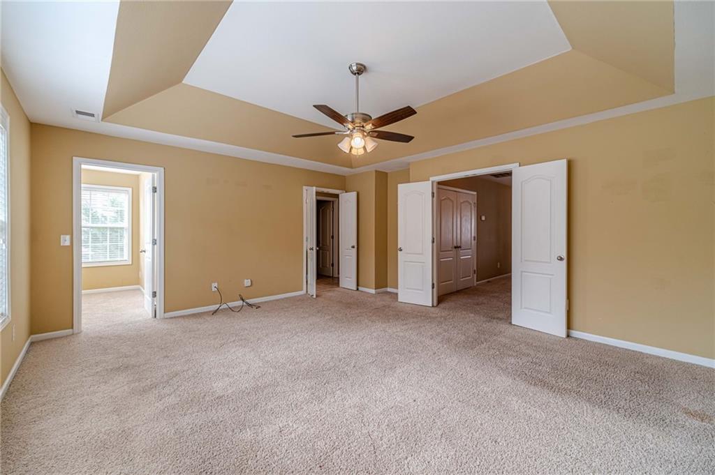 6503 Silk Tree Pointe Braselton, GA 30517 - Photo 31 of 47 an empty room with closet and a ceiling fan
