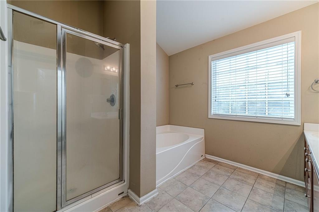 6503 Silk Tree Pointe Braselton, GA 30517 - Photo 34 of 47 a bathroom with a bathtub and a window
