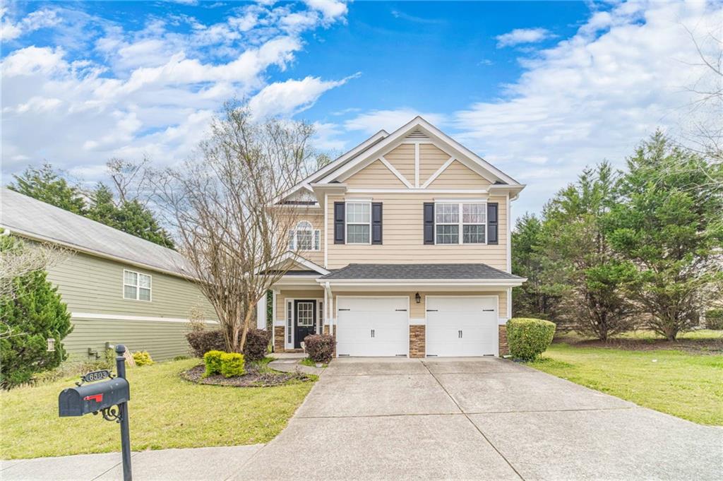 6503 Silk Tree Pointe Braselton, GA 30517 - Photo 46 of 47 a front view of a house with a yard and garage
