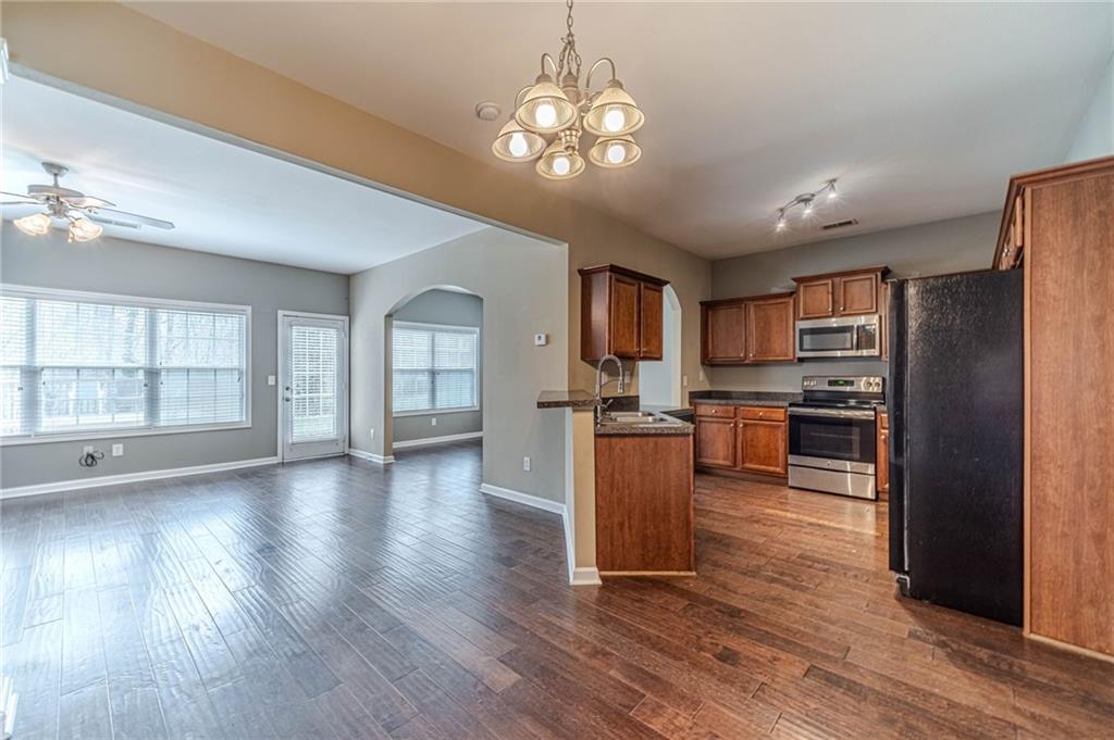 6503 Silk Tree Pointe Braselton, GA 30517 - Photo 7 of 47 a open kitchen with cabinets wooden floor and stainless steel appliances