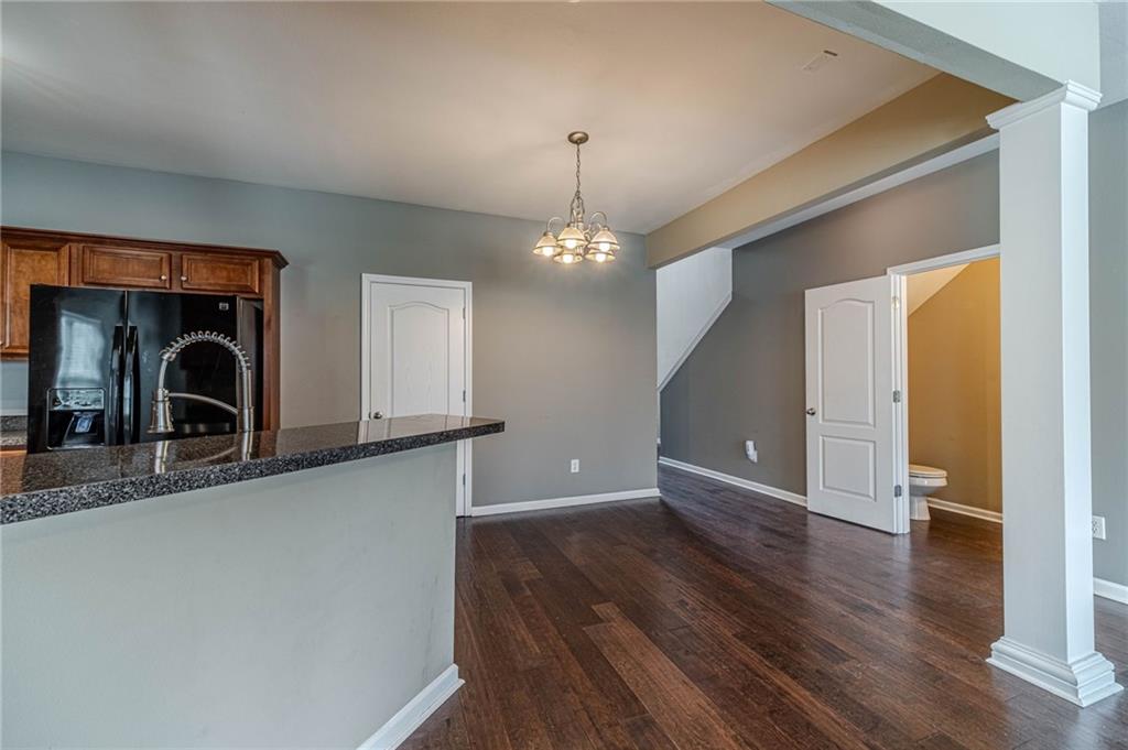 6503 Silk Tree Pointe Braselton, GA 30517 - Photo 8 of 47 a view of a hallway to an empty room with wooden floor and a window