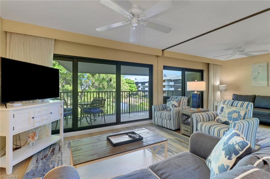 600 Neapolitan Way, Unit 345 Naples, FL 34103 - Photo 14 of 43 Living area featuring ceiling fan and wood finished floors