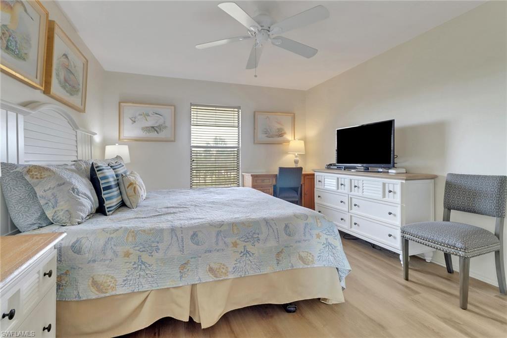 600 Neapolitan Way, Unit 345 Naples, FL 34103 - Photo 23 of 43 Bedroom featuring light wood-style flooring and a ceiling fan