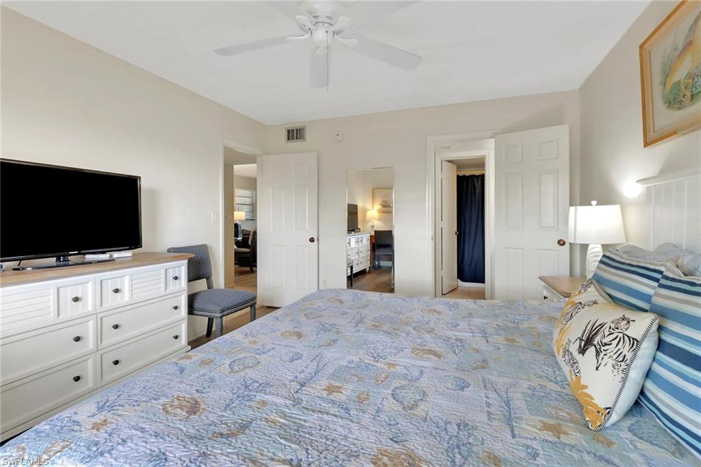 600 Neapolitan Way, Unit 345 Naples, FL 34103 - Photo 24 of 43 Bedroom with ceiling fan and wood finished floors