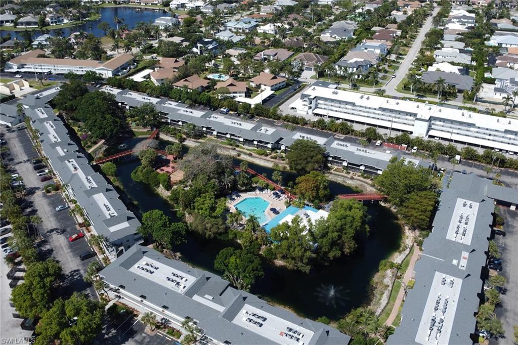 600 Neapolitan Way, Unit 345 Naples, FL 34103 - Photo 33 of 43 View of property location with a pool area, nearby suburban area, and a nearby body of water