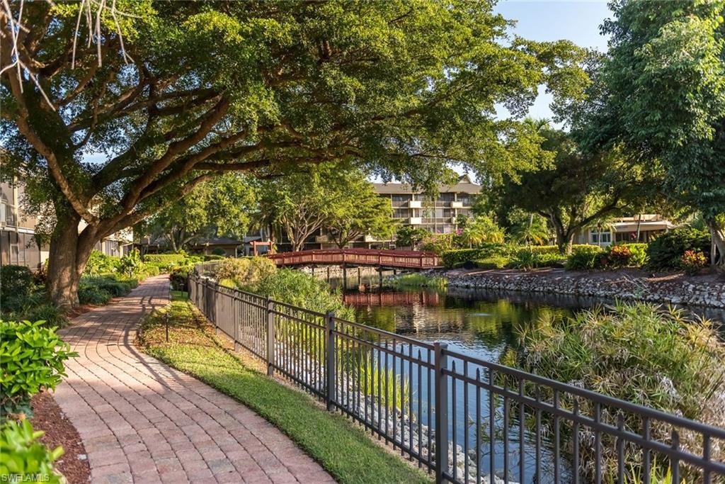 600 Neapolitan Way, Unit 345 Naples, FL 34103 - Photo 34 of 43 View of property's community with a water view and fence