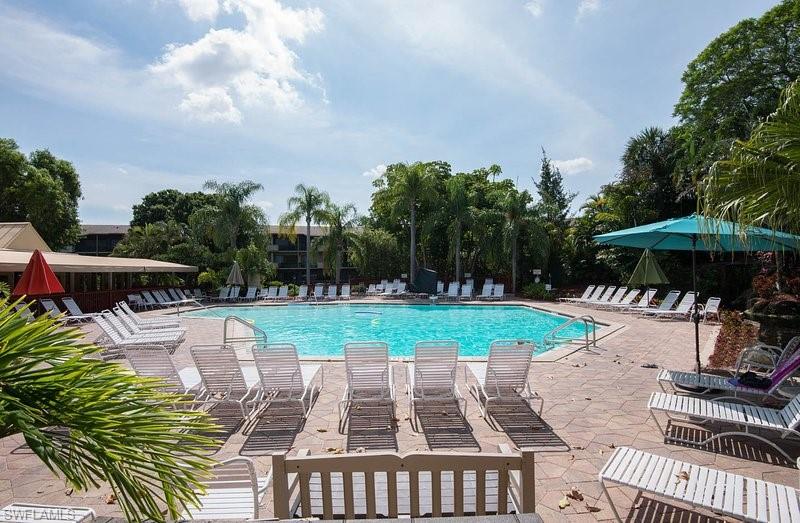 600 Neapolitan Way, Unit 345 Naples, FL 34103 - Photo 36 of 43 Community pool featuring a patio area