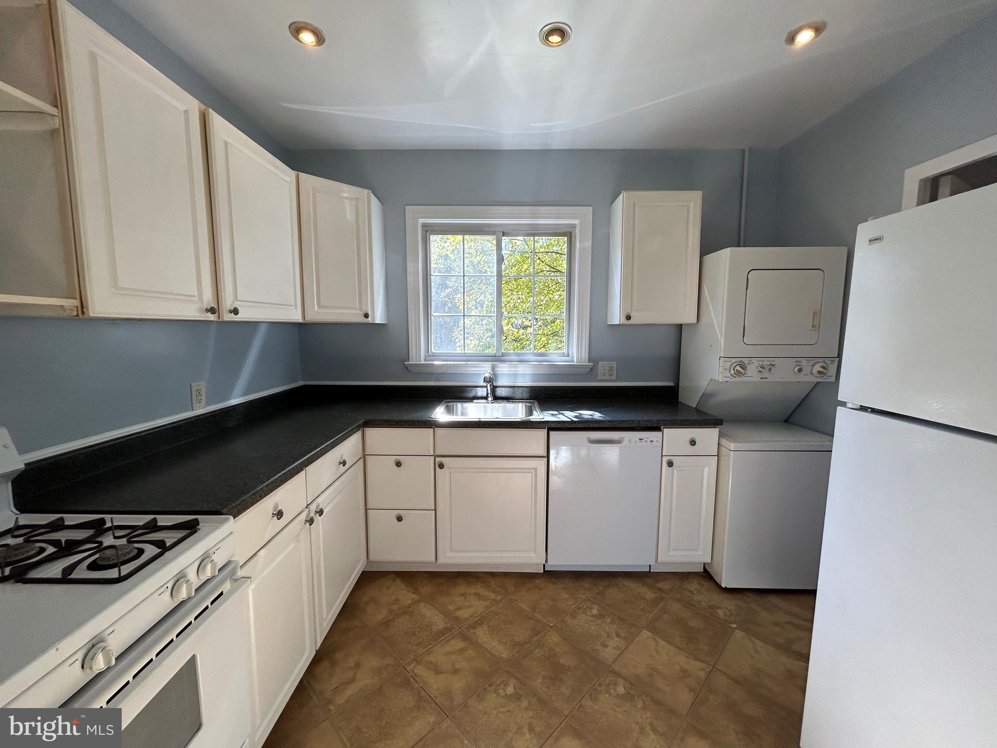 3318 Coryell Lane Alexandria, VA 22302 - Photo 7 of 29 a kitchen with a white cabinets and white appliances