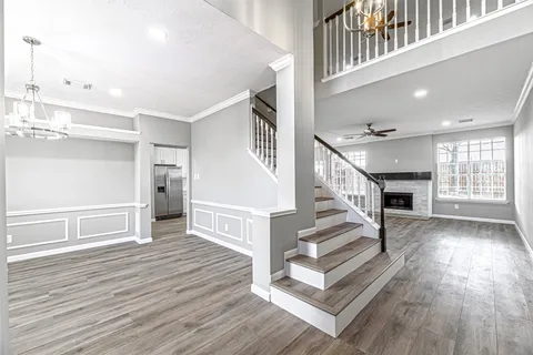 a view of entryway and hall with wooden floor