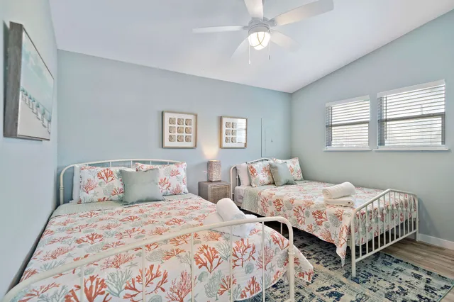 a bedroom with two beds and a chandelier