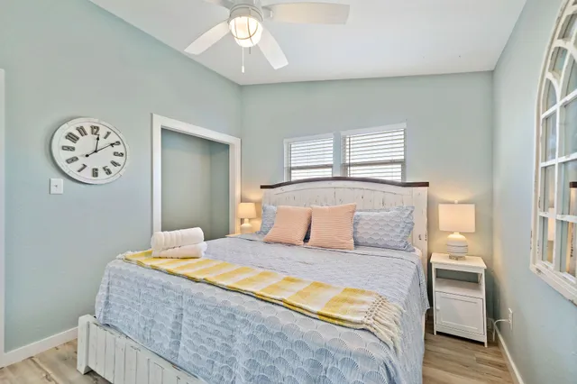 a bedroom with a large bed and a chandelier