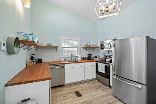 a kitchen with stainless steel appliances granite countertop a refrigerator and a stove top oven